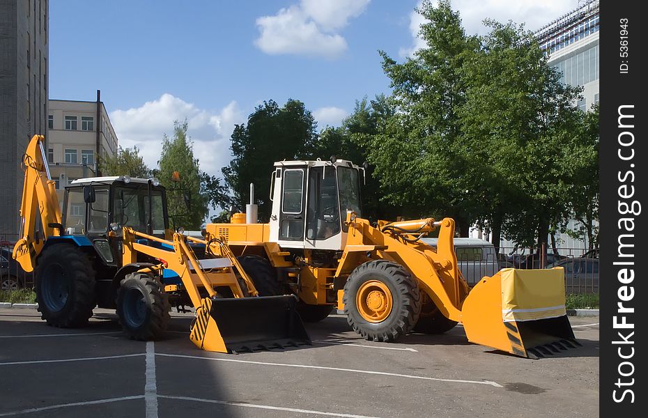 Two bulldozer on asphalt road. Two bulldozer on asphalt road