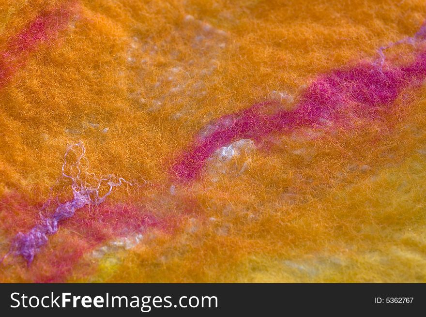 Colorful felted wool on silk texture close-up background. Colorful felted wool on silk texture close-up background