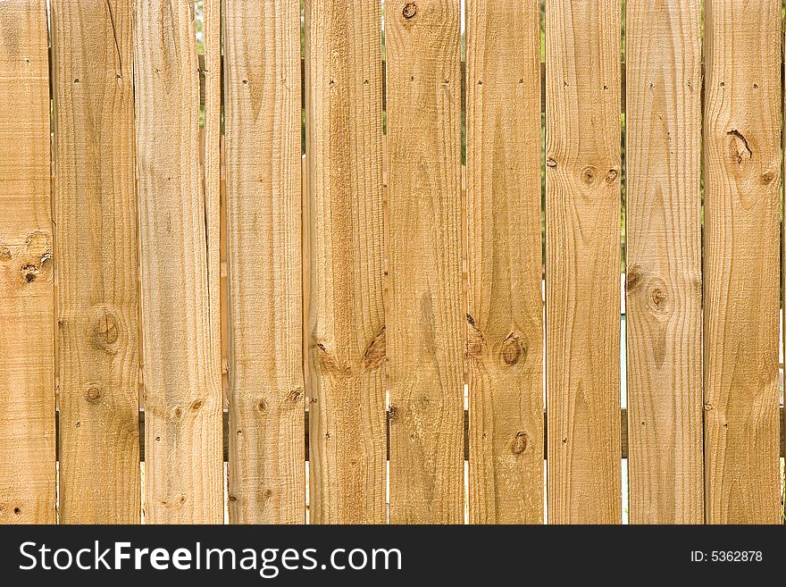 A new fence of rough pine planks. A new fence of rough pine planks