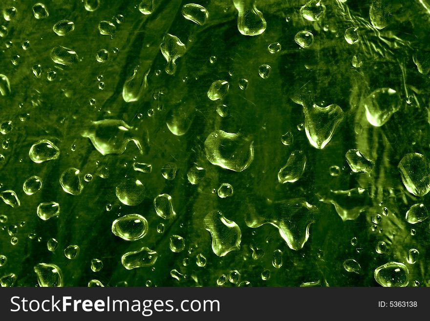 A lot of drops on green background