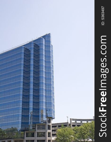A modern glass office tower in three shades of blue. A modern glass office tower in three shades of blue