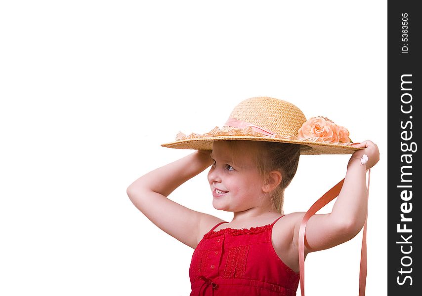 A little girl in a red dress posing with a big straw hat. A little girl in a red dress posing with a big straw hat