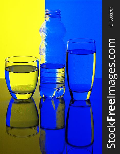 Glasses and bottle with water with background