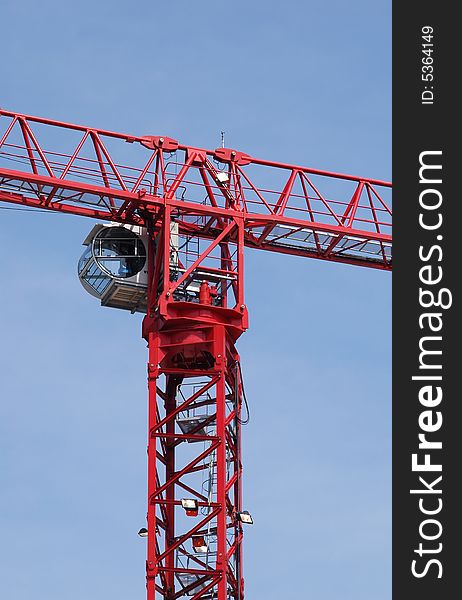 Construction crane abstract against a bright blue sky