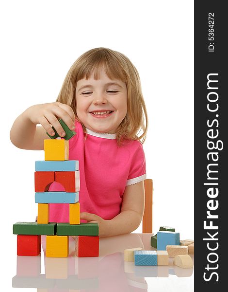 Little girl playing with cubes isolated on a white background