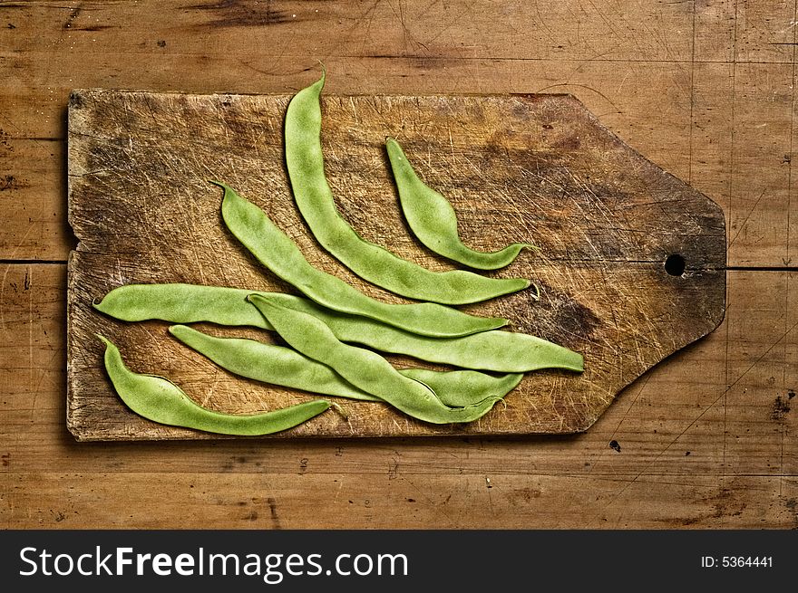 Green beans on wooden table. Studio shot.