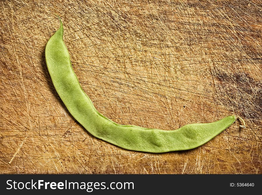 Fresh green bean on wooden table.