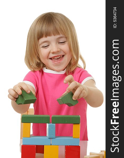 Little girl playing with cubes isolated on a white background