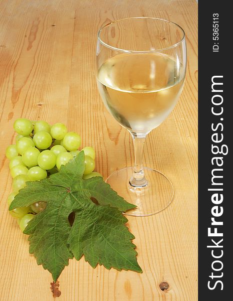 Glass of white wine with a bunch of grapes. Glass of white wine with a bunch of grapes