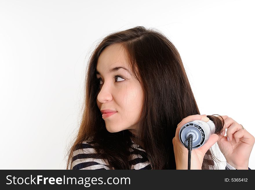 Beautiful brunette woman drying her hair with a dryer. Beautiful brunette woman drying her hair with a dryer