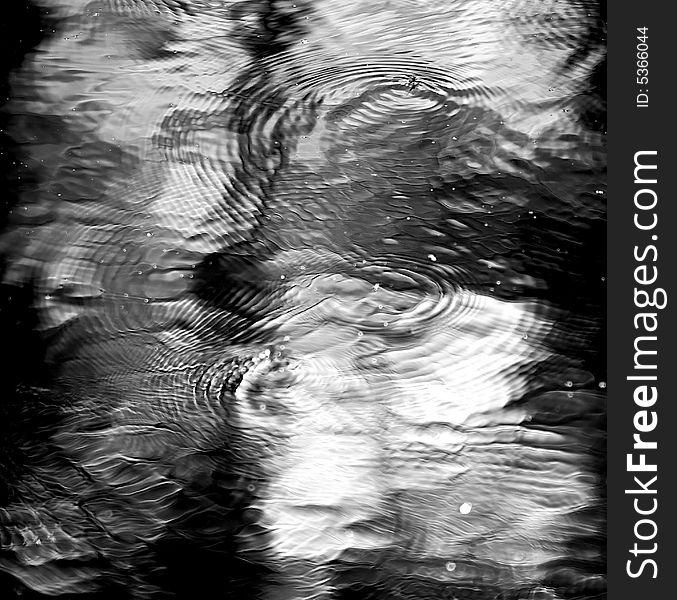 Gnats dancing on the surface of a river, causing ripples and abstract patterns. Gnats dancing on the surface of a river, causing ripples and abstract patterns