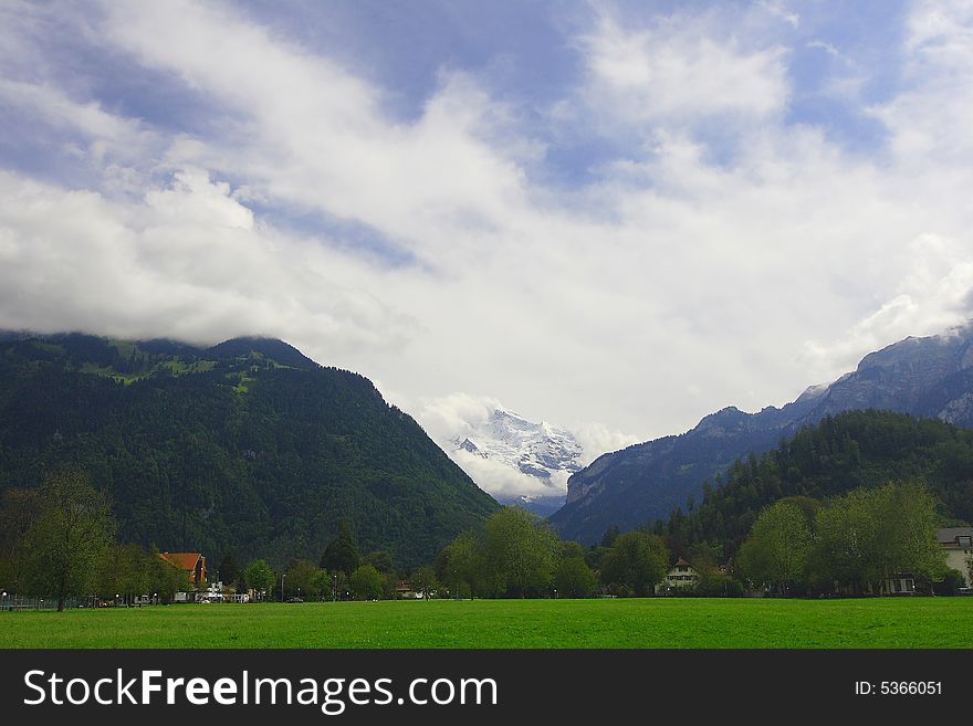 Kind on mountain Jungfrau from city park of the city of Interlaken