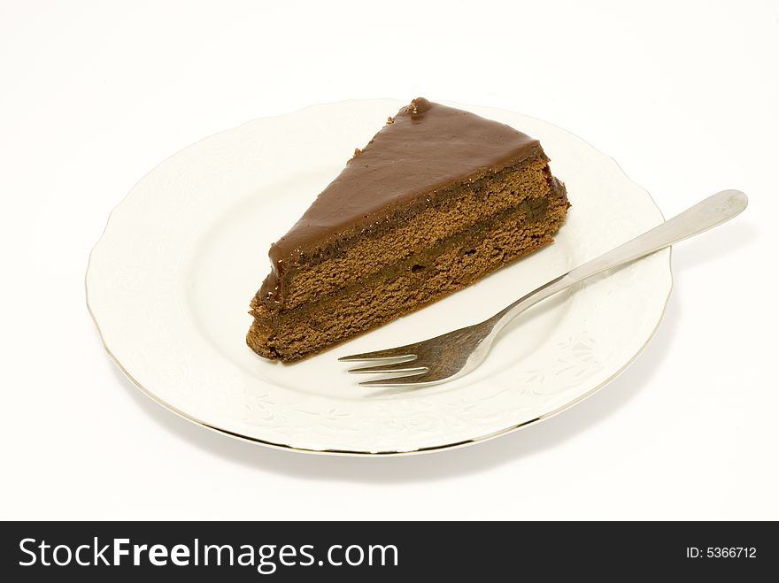 Chocolate cake with a fork, still-life over white background. Chocolate cake with a fork, still-life over white background