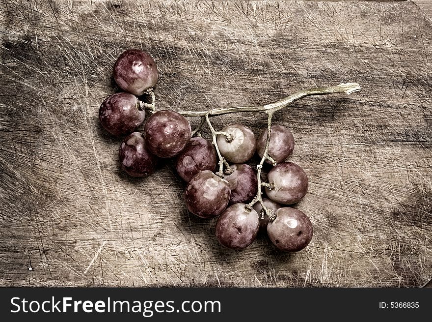 Grapes on wooden table, siolated.