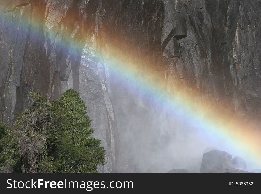 Colorful rainbow over the famous natural landmark Yosemite fall. Yosemite national park. California. USA