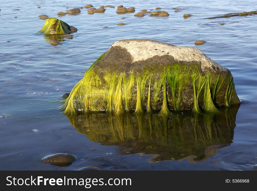 Green Colored Stones In Blue Sea