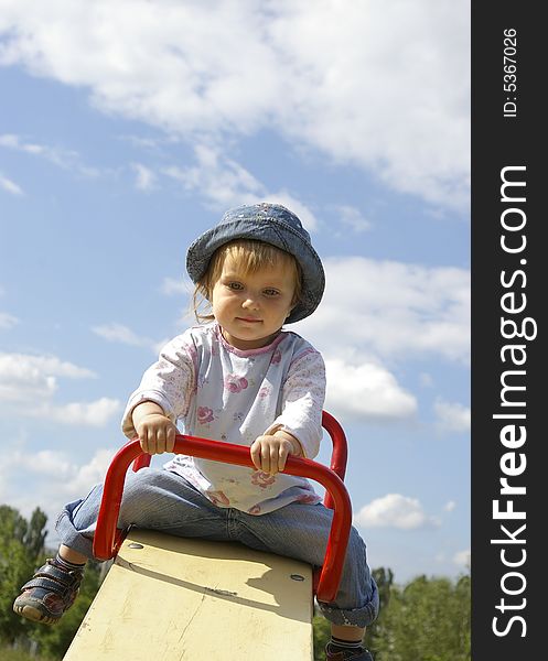 Cute Girl Swinging In The Park