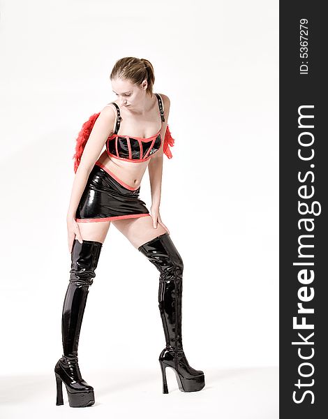 Studio portrait of a fetish model in very high boots. Studio portrait of a fetish model in very high boots