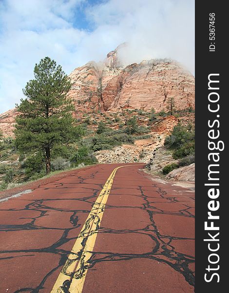 Red road leading to the mountains of the Zion National Park. Utah. USA. Red road leading to the mountains of the Zion National Park. Utah. USA