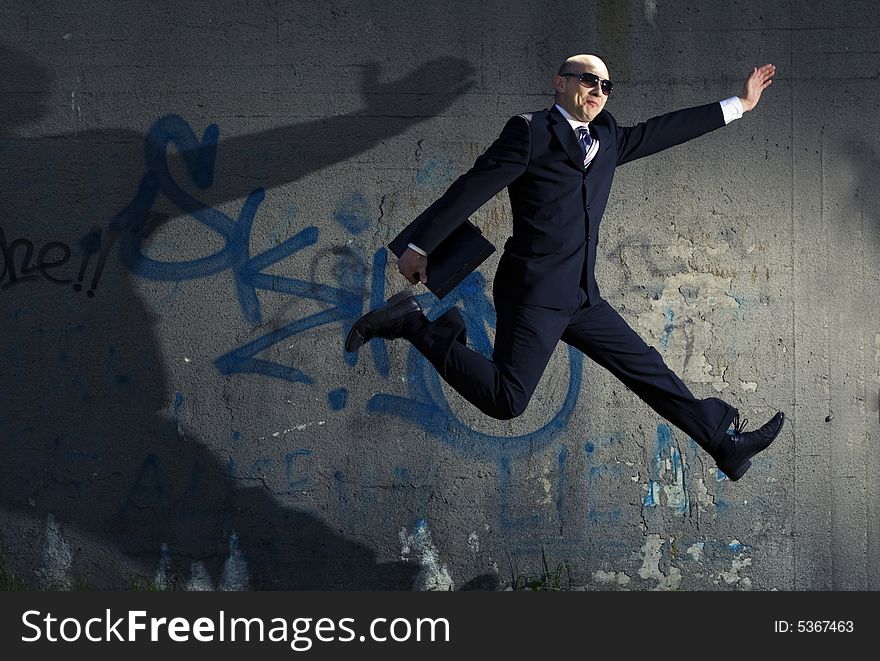 Businessman jumping against the wall. Businessman jumping against the wall.