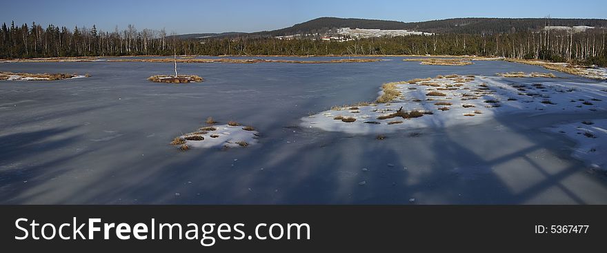 This is Chaluparska moor in Czech republic, region Sumava. There was a few snow in February 2007, normally you would not get here by foot. It was a beautiful sunset throwing soft light and long shadows on the frozen surface of the moor. This is Chaluparska moor in Czech republic, region Sumava. There was a few snow in February 2007, normally you would not get here by foot. It was a beautiful sunset throwing soft light and long shadows on the frozen surface of the moor...