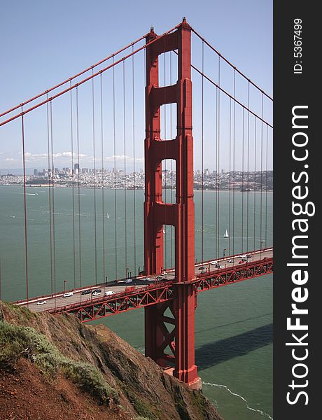 A traffic flows along the glowing Golden Gate Bridge. San Francisco, California, USA. A traffic flows along the glowing Golden Gate Bridge. San Francisco, California, USA