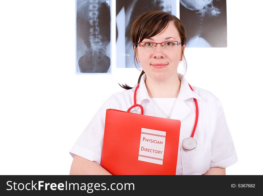 Young female doctor holds red folder, x-rays as background, isolated on white