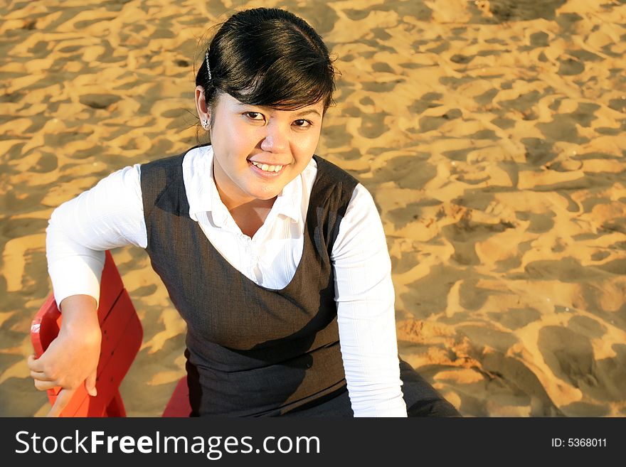 Woman with business suit at beach