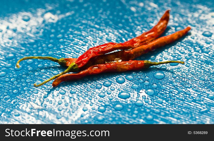 Dried red chili peppers and water drops.