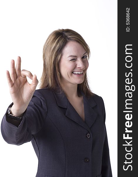 Businesswoman giving the OK sign isolated on white with studio lighting