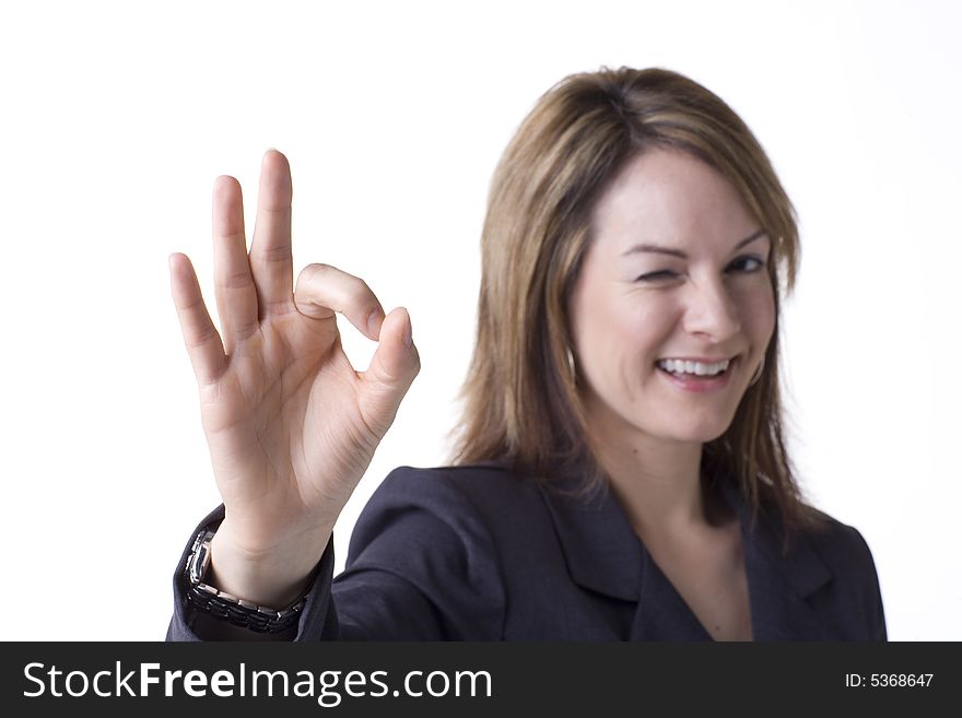 Businesswoman giving the OK sign isolated on white with studio lighting