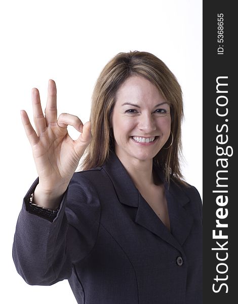 Businesswoman giving the OK sign isolated on white with studio lighting