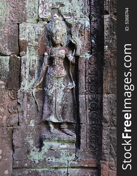 Cambodia, Angkor: The Preah Khan from 12th century it was a temple and a Buddhist university; the walls and pillars are decorated with mythological figures as this carved stone goddess.