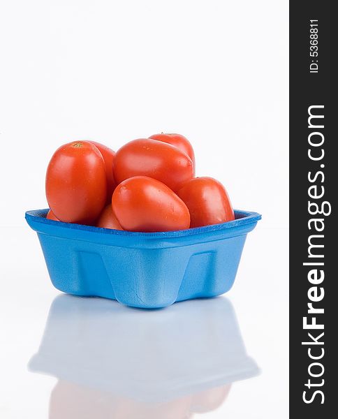 Fresh tomatoes in a blue basket. Fresh tomatoes in a blue basket