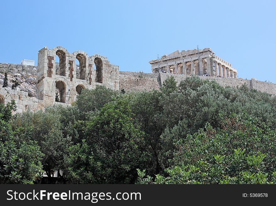 A view of the Acropolis of Athens (Greece) and a part of the facade of the ancient theater of Herod Atticus. A view of the Acropolis of Athens (Greece) and a part of the facade of the ancient theater of Herod Atticus