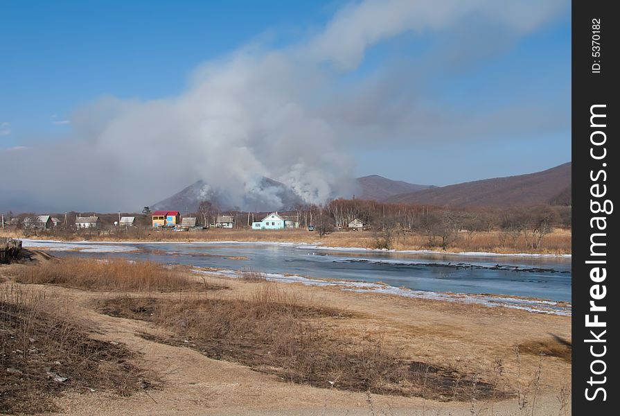 A big forest fire behind a village. Russian Far East, Primorye, Sokolovka village. A big forest fire behind a village. Russian Far East, Primorye, Sokolovka village.