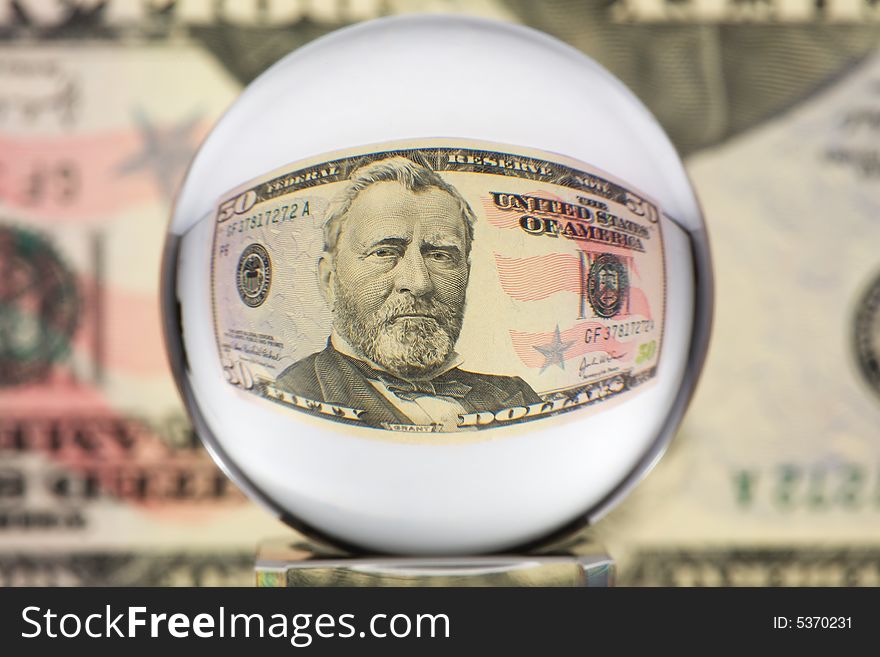 Fifty dollar banknote through glass sphere. Blur background. Fifty dollar banknote through glass sphere. Blur background.