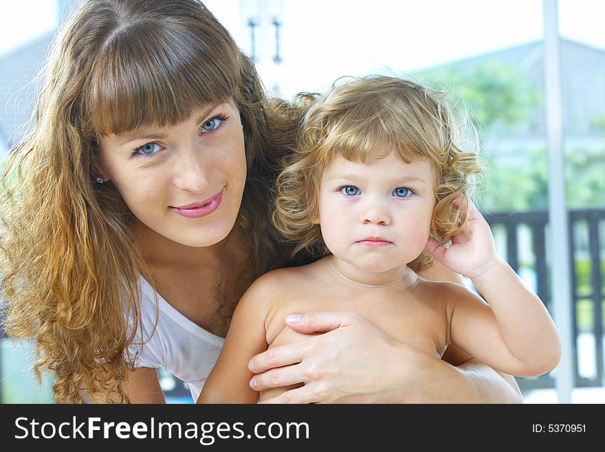 High key portrait of happy mother with baby. High key portrait of happy mother with baby