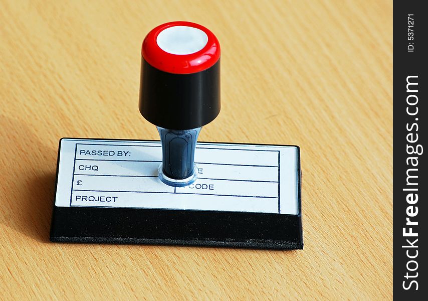 Shot of an office stamp on a desk. Shot of an office stamp on a desk