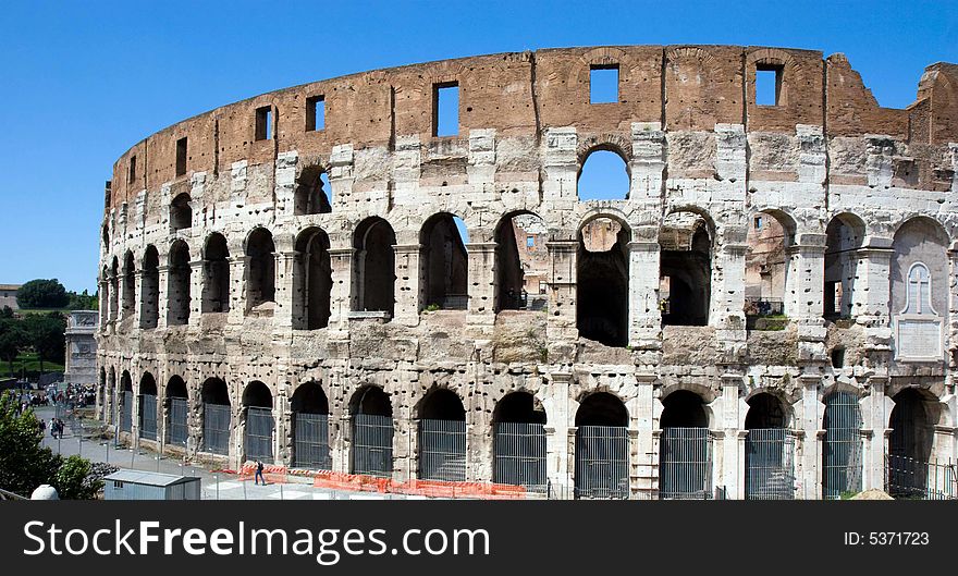 The Imperial Roman Coliseum with a blue sky background, Rome, Italy. The Imperial Roman Coliseum with a blue sky background, Rome, Italy