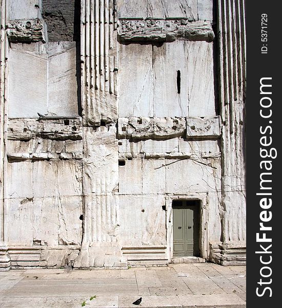 Small door in a massive wall in an ancient building; Rome, Italy