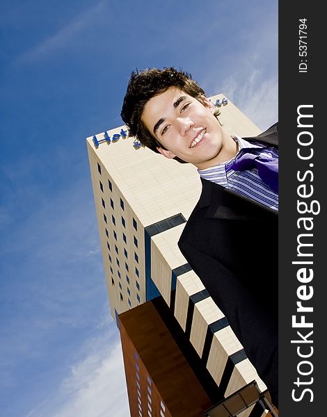 Young businessman portrait against urban background