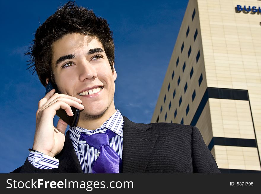 Businessman on phone over urban background