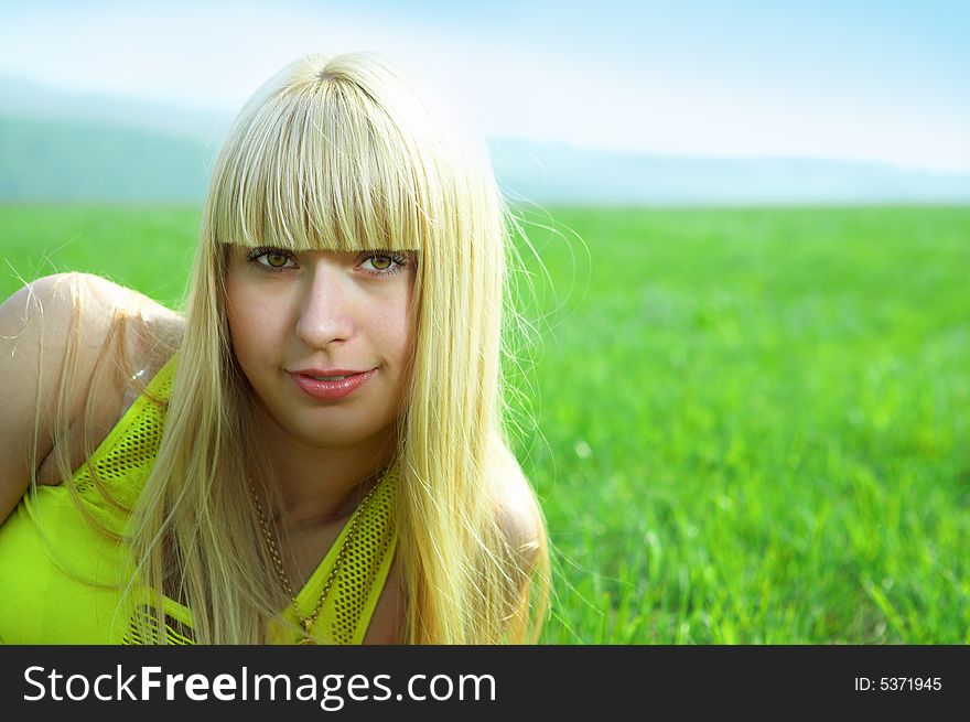 Happy beauty young woman jump in field with green grass