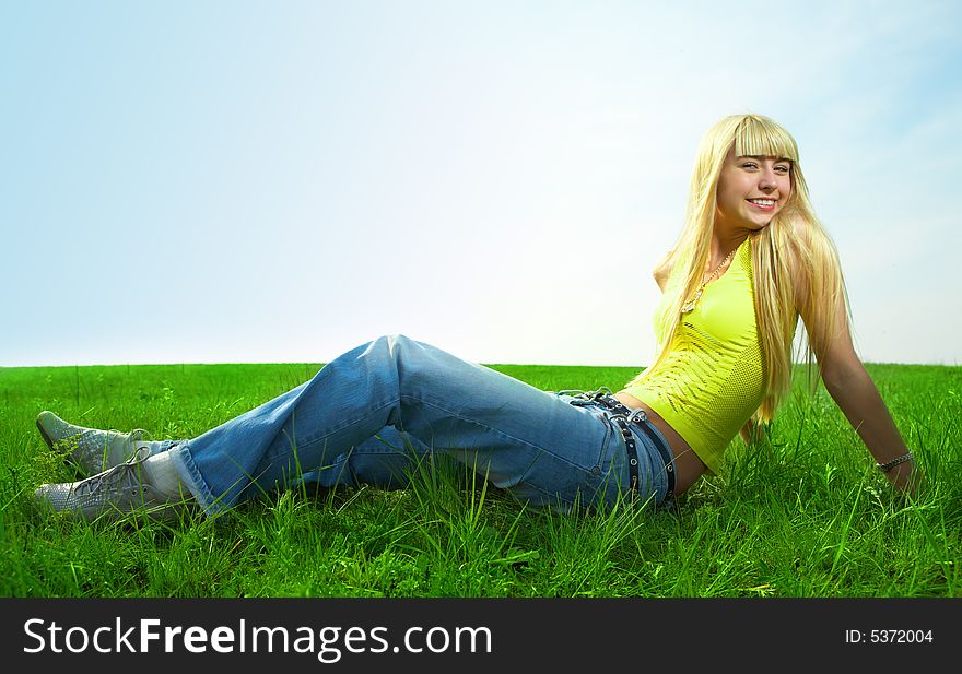 Happy beauty young woman jump in field with green grass