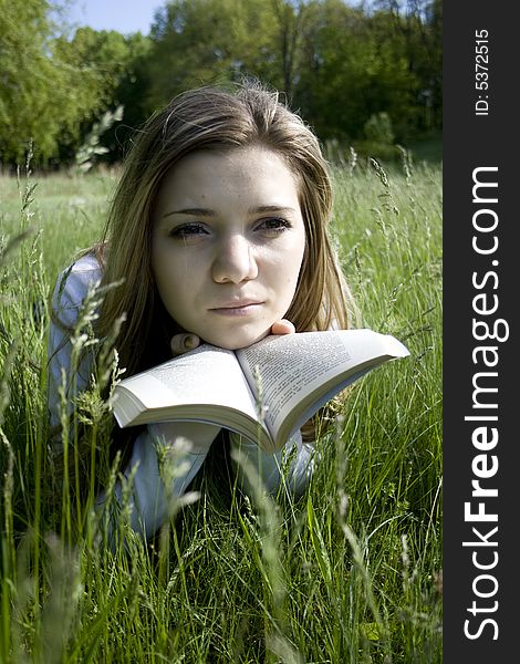 Girl reading a book outdoor