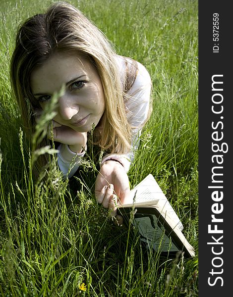 Girl read book on meadow. Girl read book on meadow