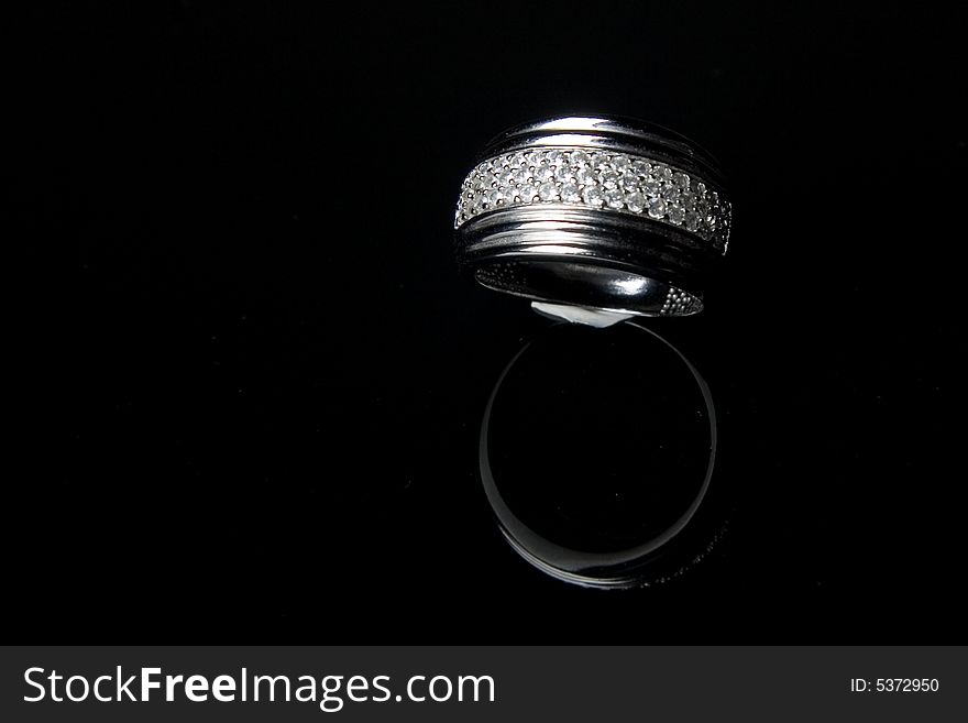 Diamond ring with reflection in isolated black bac