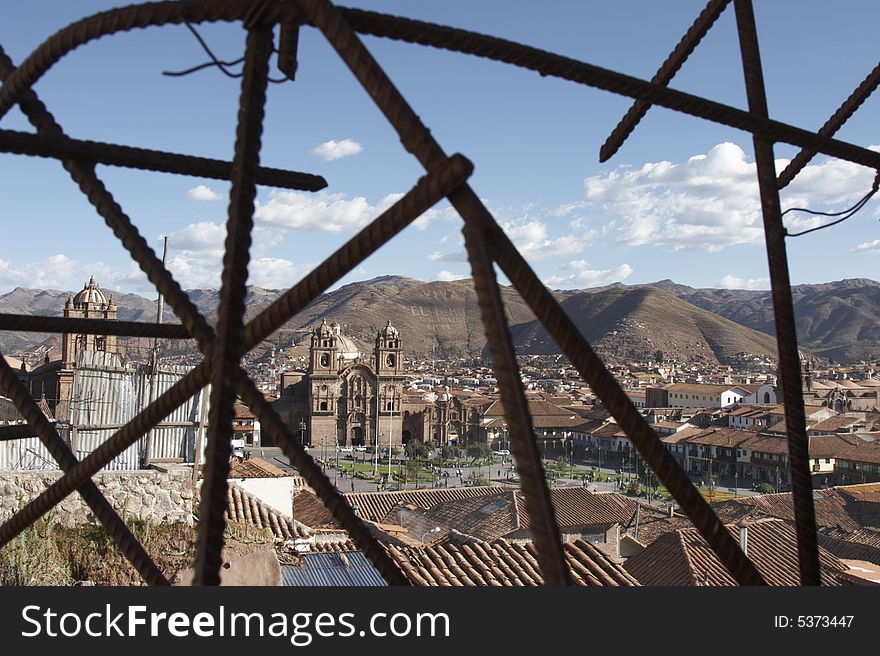 View of the Plaza de Armas in Cusco Peru through a twisted web of rebar. View of the Plaza de Armas in Cusco Peru through a twisted web of rebar.
