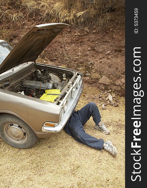 Man repairing a car near Cusco, Peru. Man repairing a car near Cusco, Peru.